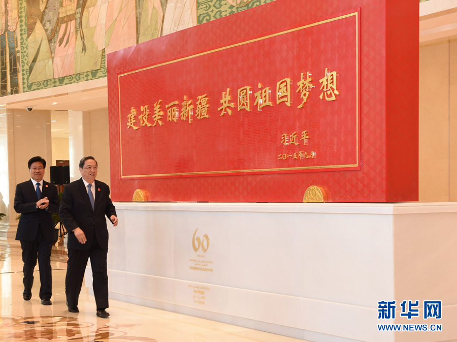 這是俞正聲和中共中央政治局委員、新疆維吾爾自治區(qū)黨委書記張春賢一同為習(xí)近平總書記題詞賀匾揭幕。新華社記者 高潔 攝 